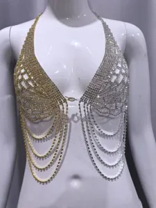 Close-up detail of luxury rhinestone angel wings body chain, dazzling gold and silver tones.