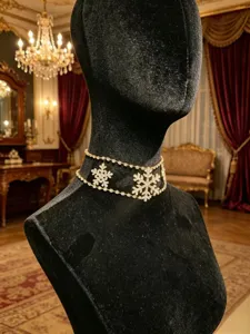 Detailed shot of double layer rhinestone snowflake choker necklace showing sparkling crystal details.