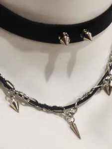 Detail shot of punk gothic leather choker and metal chain spike necklace for women gothic style.