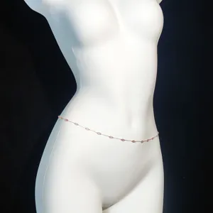 Elegant rose gold waist chain with pink geometric crystals, versatile summer body jewelry.