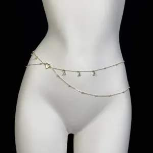 Gold layered waist chain with shimmering rhinestones and heart pendant, sexy beach body jewelry.