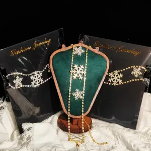 Chic rhinestone snowflake necklace and body chain set featuring sparkling crystal designs for women.