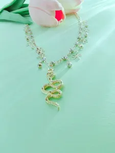 Detailed view of trendy gold layered anklet featuring snake pendant and cute bow charms.