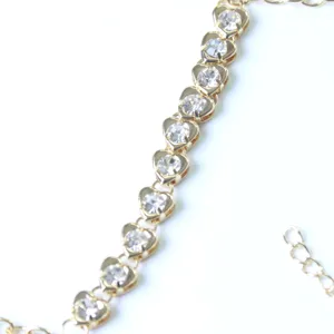 Gold heart rhinestone body chain detail shot, sparkling crystal links jewelry close up view