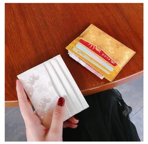 Detail view of minimalist card holder with carriage print, multiple slots, slim and compact.
