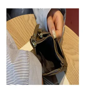 Detail view of genuine leather coin purse interior, dual zipper pocket, premium texture.