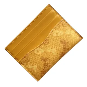 Yellow leather card holder with classic horse carriage print, slim minimalist wallet.