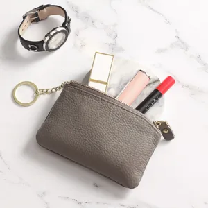 Minimalist genuine leather coin purse for women with zipper and key ring. Stylish daily accessory.