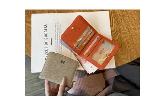 Compact leather wallet for women with card slots and coin pocket, stylish short design.