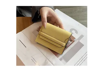 Minimalist yellow leather card holder for women, compact mini wallet with flap design.