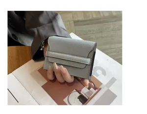 Grey genuine leather minimalist card holder detail showing compact folding design.