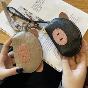Cute leather coin purse for women, mini pig design wallet with wrist strap and zipper closure.