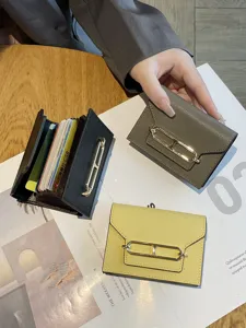 Genuine leather multi-slot card holder for women, stylish accordion wallet with metal clasp.
