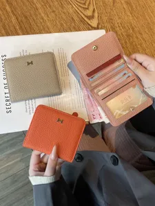 Genuine leather short wallet for women, minimalist compact card holder with metal H buckle.