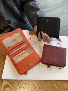 Genuine leather women's short wallet featuring multiple card slots and a stylish metal H clasp design.
