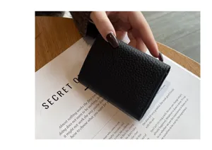 Compact women's genuine leather short trifold wallet mini purse with multiple card slots.
