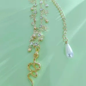 Gold layered snake pendant anklet with rhinestones and pearl drop for summer beach style.