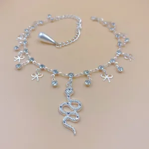 Silver rhinestone snake anklet with cute bows and pearl detail for women sparkling fashion.