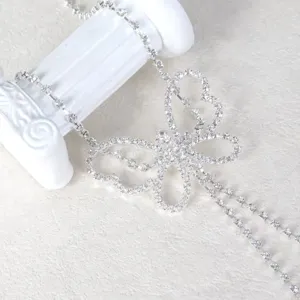Exquisite rhinestone butterfly waist chain detail, luxurious silver metal body jewelry.