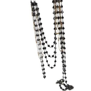 Multi-strand long layered necklace with dark heart beads and metallic chains for women.