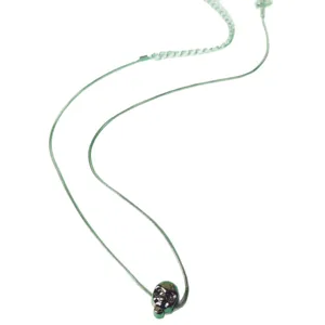 Dark skull pendant necklace with light green cord, gothic style fashion jewelry.