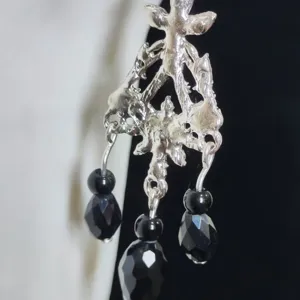 Exaggerated gothic silver metal body chain pendant with black crystal teardrop beads.