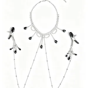 Gothic rhinestone body chain with black teardrop pendants and matching nipple clamps.