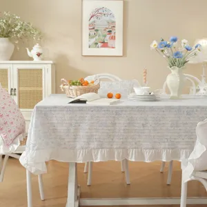Detailed view of the pastoral style cotton jacquard tablecloth with floral print and ruffles.