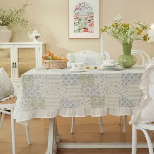 Detail view of the American floral patchwork tablecloth showcasing its delicate white ruffles.