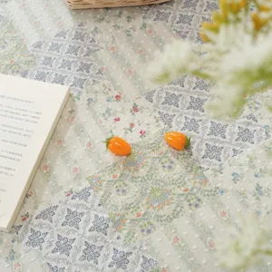 Detail shot of cotton printed patchwork tablecloth featuring vintage floral and geometric patterns.