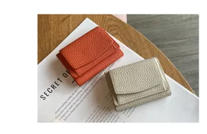 Genuine leather trifold mini wallet for women with coin pocket and snap closure detail view.
