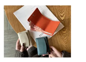 Detailed view of genuine leather trifold mini short wallets in multiple chic colors.
