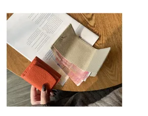 Genuine leather trifold mini wallet with card slots and coin pocket in stylish colors.