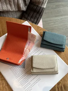 Minimalist genuine leather trifold wallet for women, compact mini coin purse with snap closure.