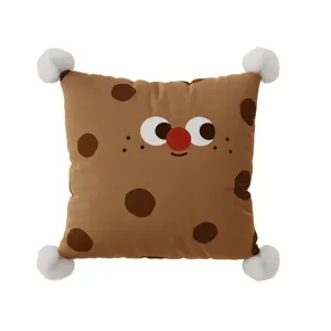 Cute cookie shaped throw pillow with plush pom poms and funny face design for sofa.