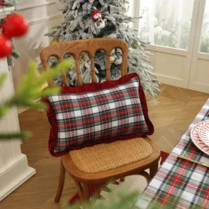 Ensemble coussin et nappe à carreaux rouges et verts de Noël, détail déco intérieure.