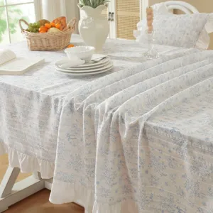 Country style floral jacquard tablecloth detail, fresh blue and white table cover with ruffles.