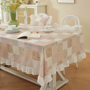 Detailed view of American style cotton patchwork tablecloth with cute white ruffle skirt hem.