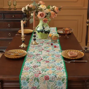 Vista dettagliata del runner da tavola jacquard floreale retrò americano con bordo verde.