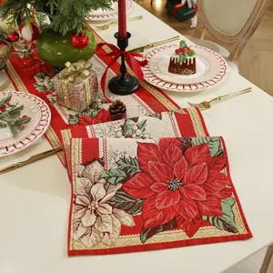 Christmas table runner detail showcasing intricate jacquard red poinsettia pattern.