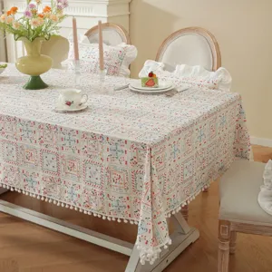 Pastoral cotton printed tablecloth with pom-pom trim and floral design for dining room.