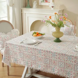 Pastoral cotton jacquard printed tablecloth with floral pattern and cute pom-pom trim for dining room.