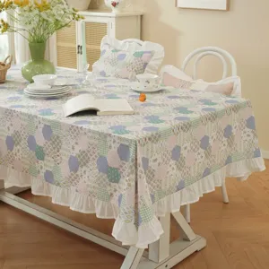 Detailed view of American pastoral cotton patchwork tablecloth with elegant white ruffled hem.