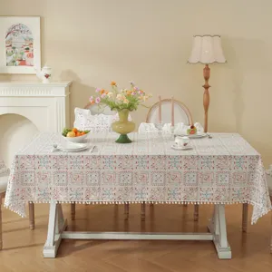 Pastoral cotton floral tablecloth detail, retro geometric grid pattern with cute white pompom balls.