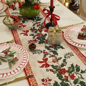 Detailed view of Christmas woven jacquard table runner with festive holly design.