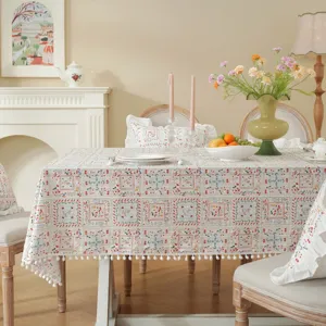 Pastoral cotton floral tablecloth with pom-pom fringe and ruffle edge for dining table decor.