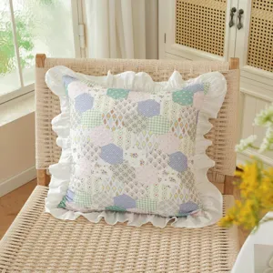 Exquisite patchwork floral cushion cover with elegant white ruffled trim for cozy home decor.