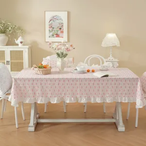 Detail shot of pastoral cotton jacquard floral tablecloth with ruffled hem for dining room.