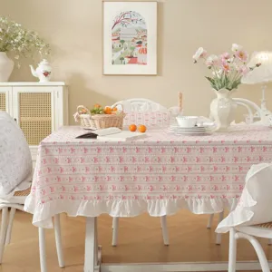 Pastorale style cotton jacquard tablecloth with bow print and delicate white ruffle hem detail.