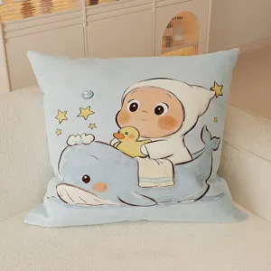 Close-up detail of a cute cartoon printed cushion with a baby and whale design on a soft sofa.